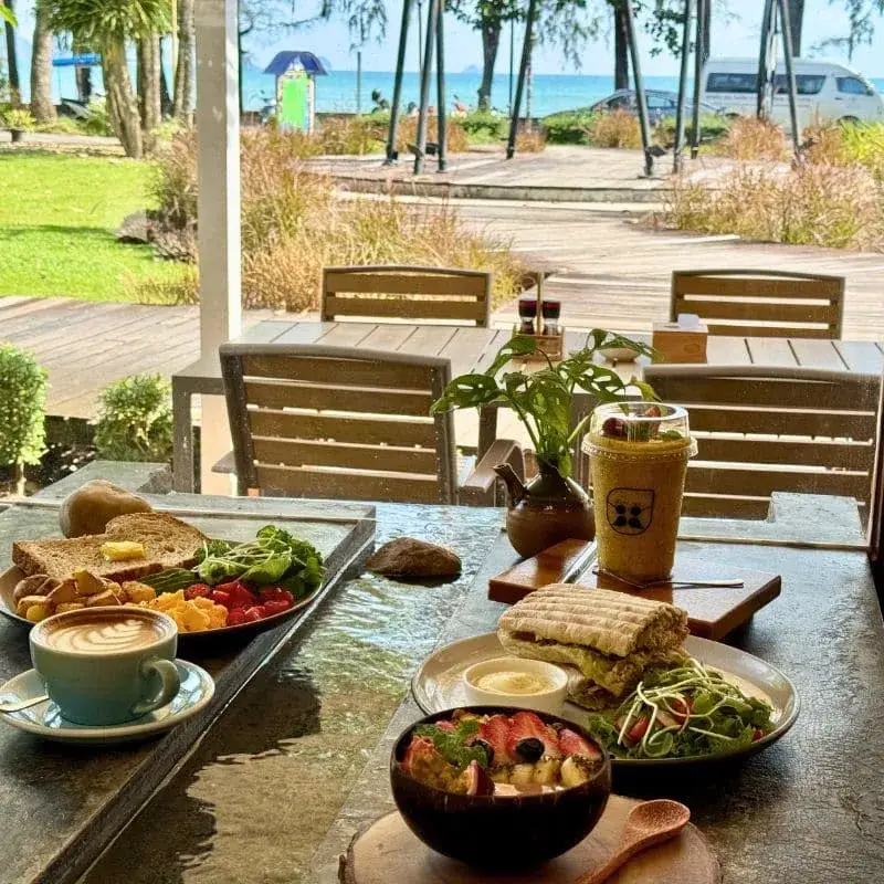 Brunch spread on the stone water table at Thongyib Thongyod with sea view